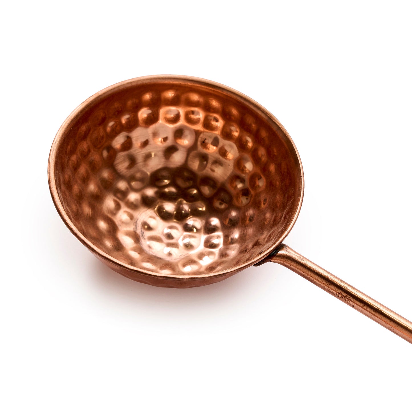 Copper ladle with wooden handle close up