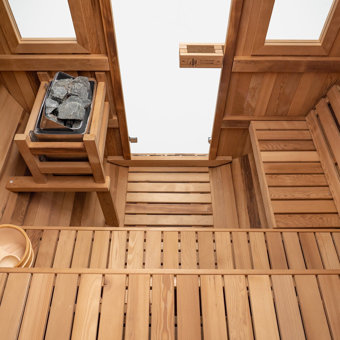 Redwood Outdoors Extra Wide 6 person Barrel Outdoor Sauna inside above view showing the two benches and a heater in the corner.