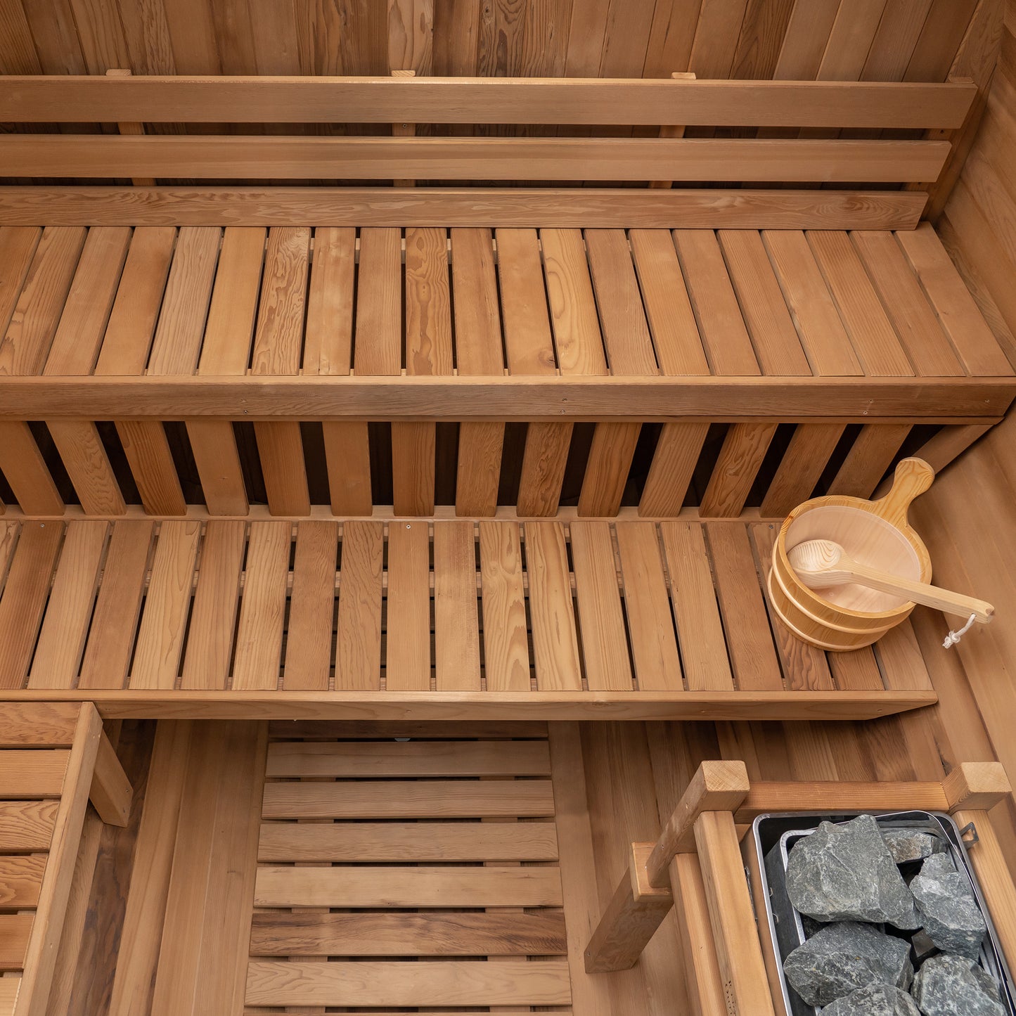 Redwood Outdoors Extra Wide 6 person Barrel Outdoor Sauna inside above view showing the two benches and a heater in the corner. 