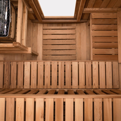 Redwood Outdoors Extra Wide 6 person Barrel Outdoor Sauna inside above view showing the two benches and a heater in the corner.