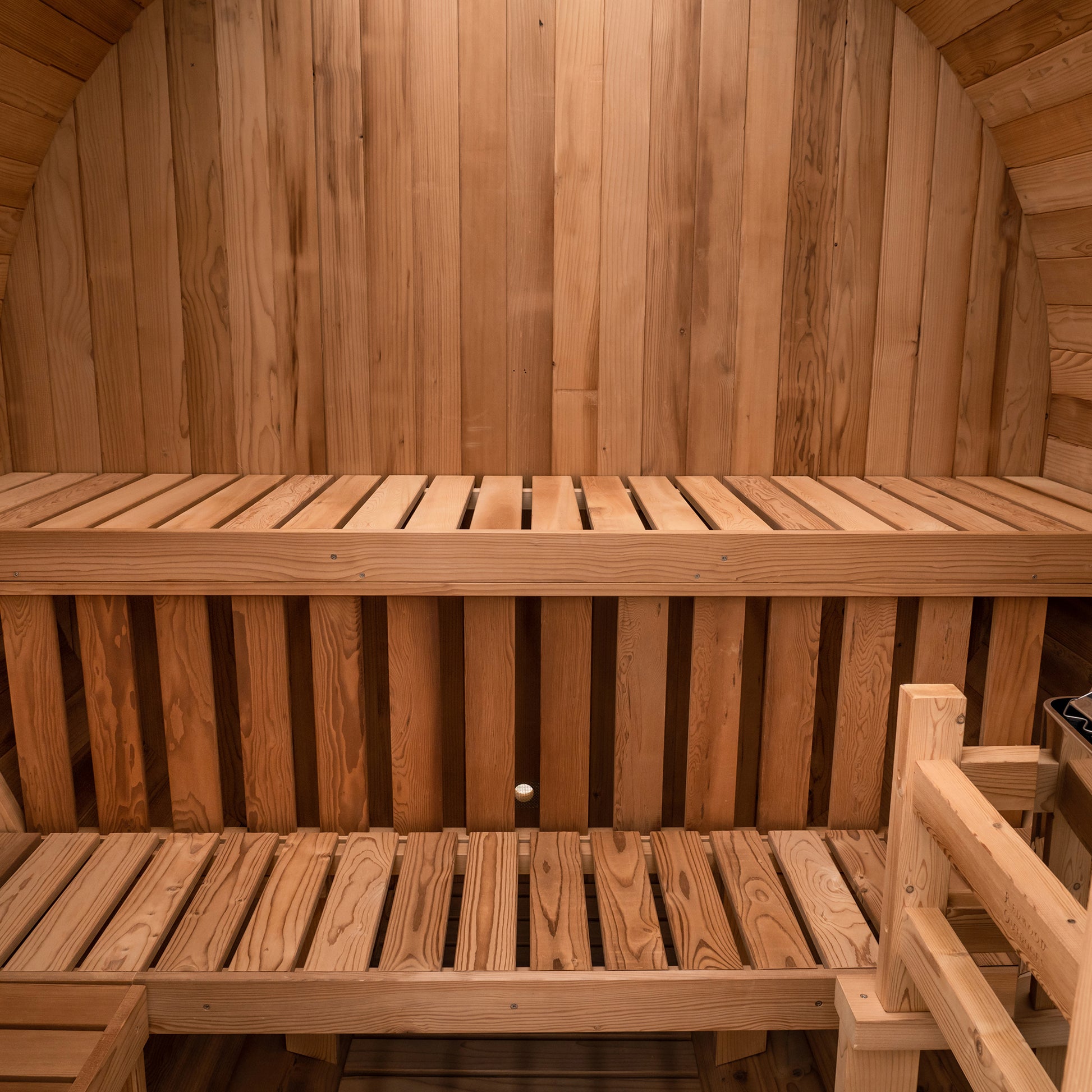 Redwood Outdoors Extra Wide 6 person Barrel Outdoor Sauna inside above view showing the two benches and a heater in the corner.