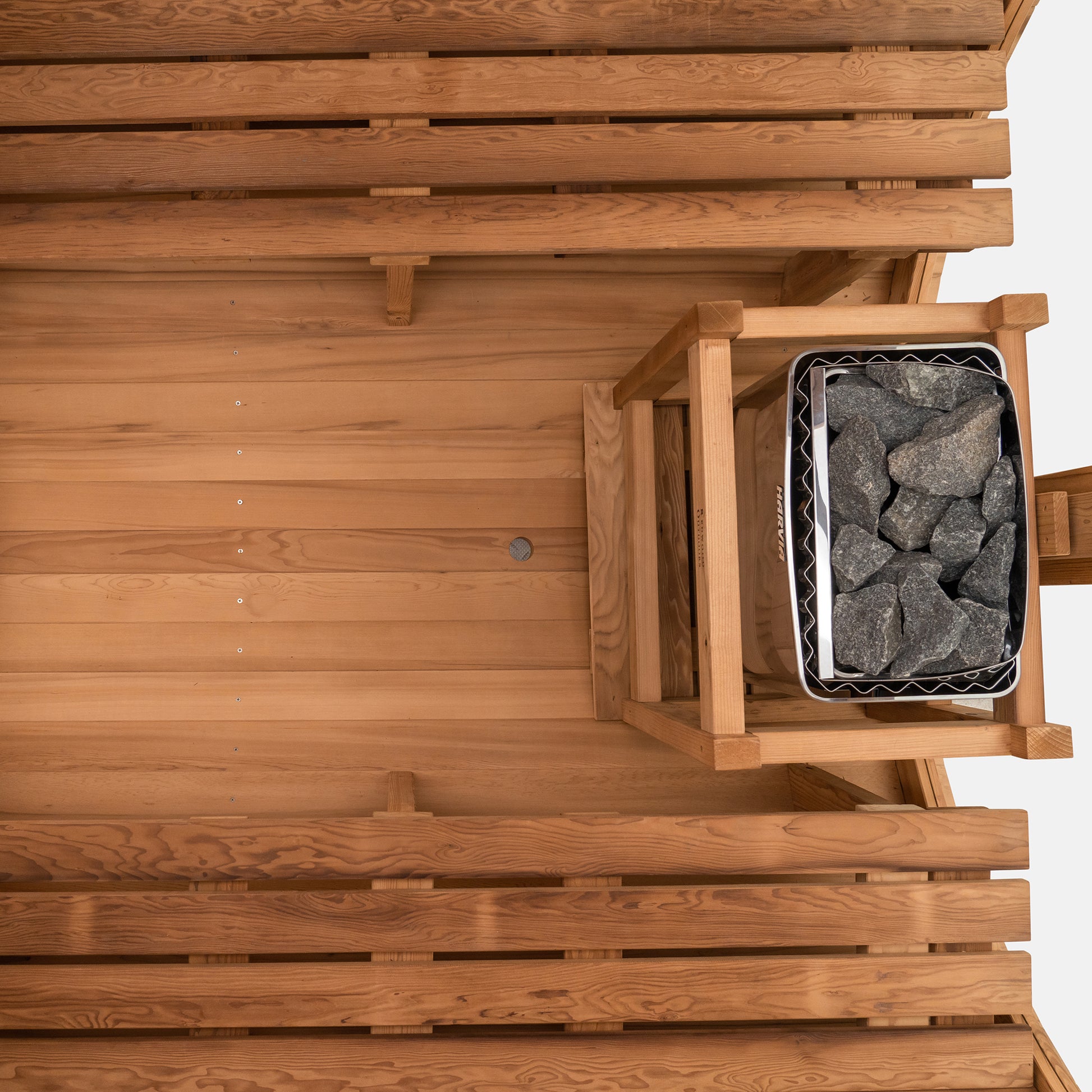 Redwood Outdoors Horizon 6 person outdoor sauna, made of hemlock wood with large rear window, heater with guard and two benches on both sides.
