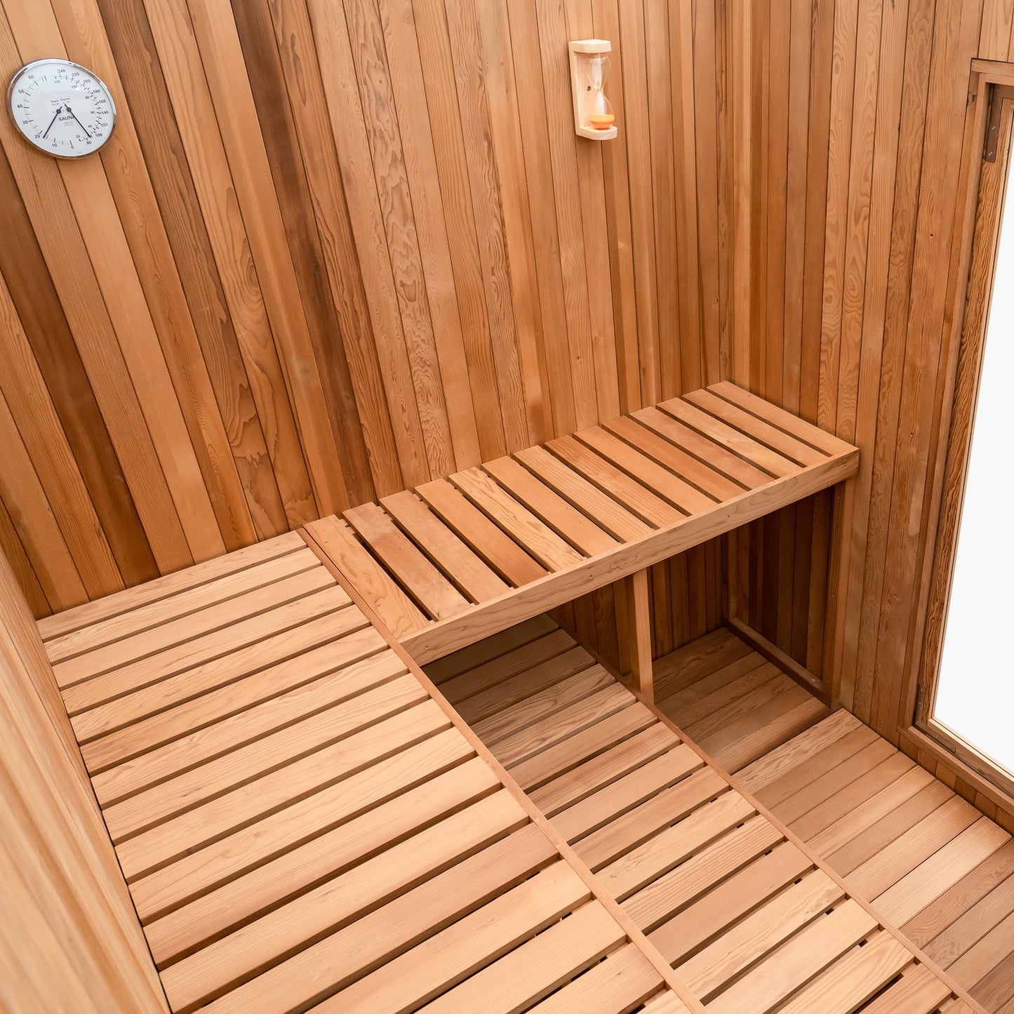 Redwood Outdoors Noctra 8 person sauna, made of hemlock wood stained black with a glass door view from the back of the sauna. 