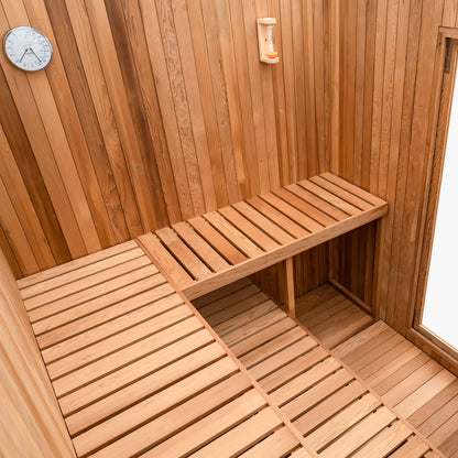 Redwood Outdoors Noctra 8 person sauna, made of hemlock wood stained black with a glass door view from the back of the sauna. 