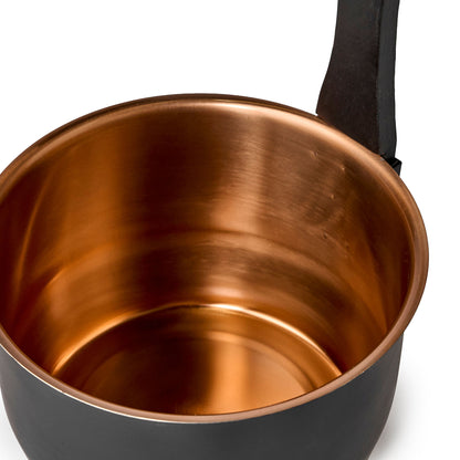 Black bucket with copper inside with a wooden handle interior view