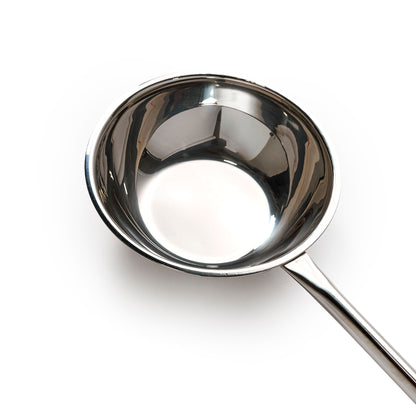 Stainless steel ladle with wooden handle closeup view