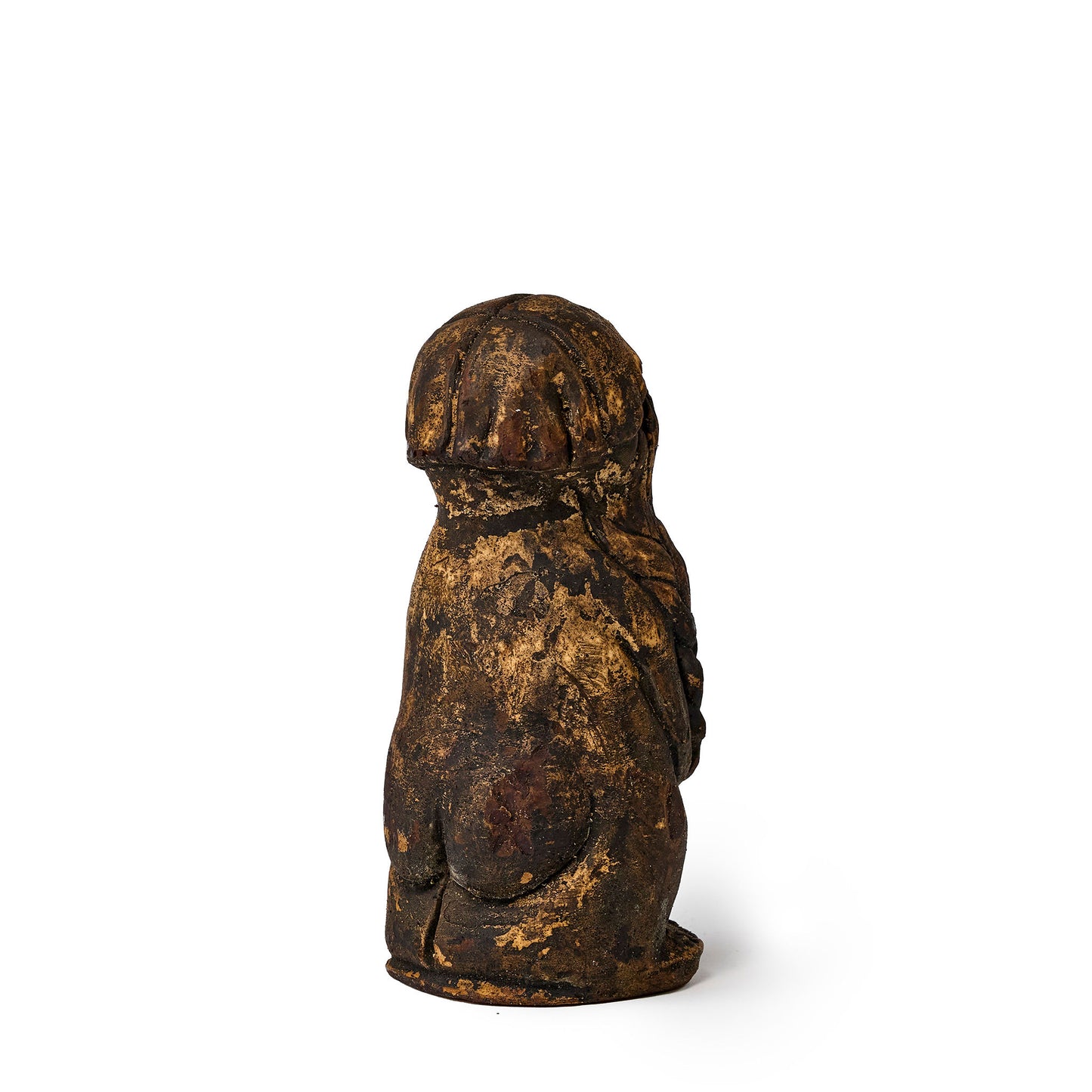 Small figure of an elf covered in pine tar back view