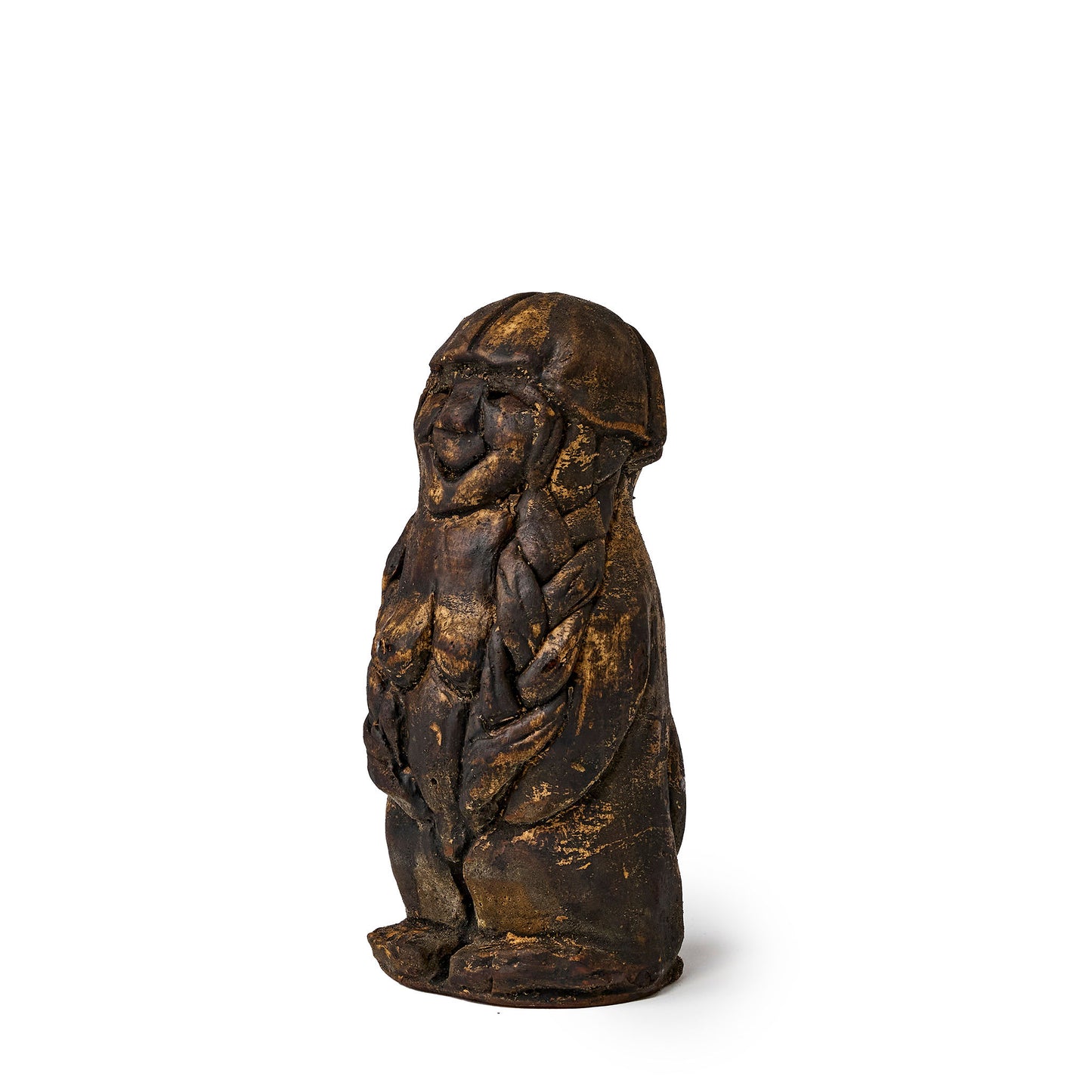Small figure of an elf covered in pine tar side view