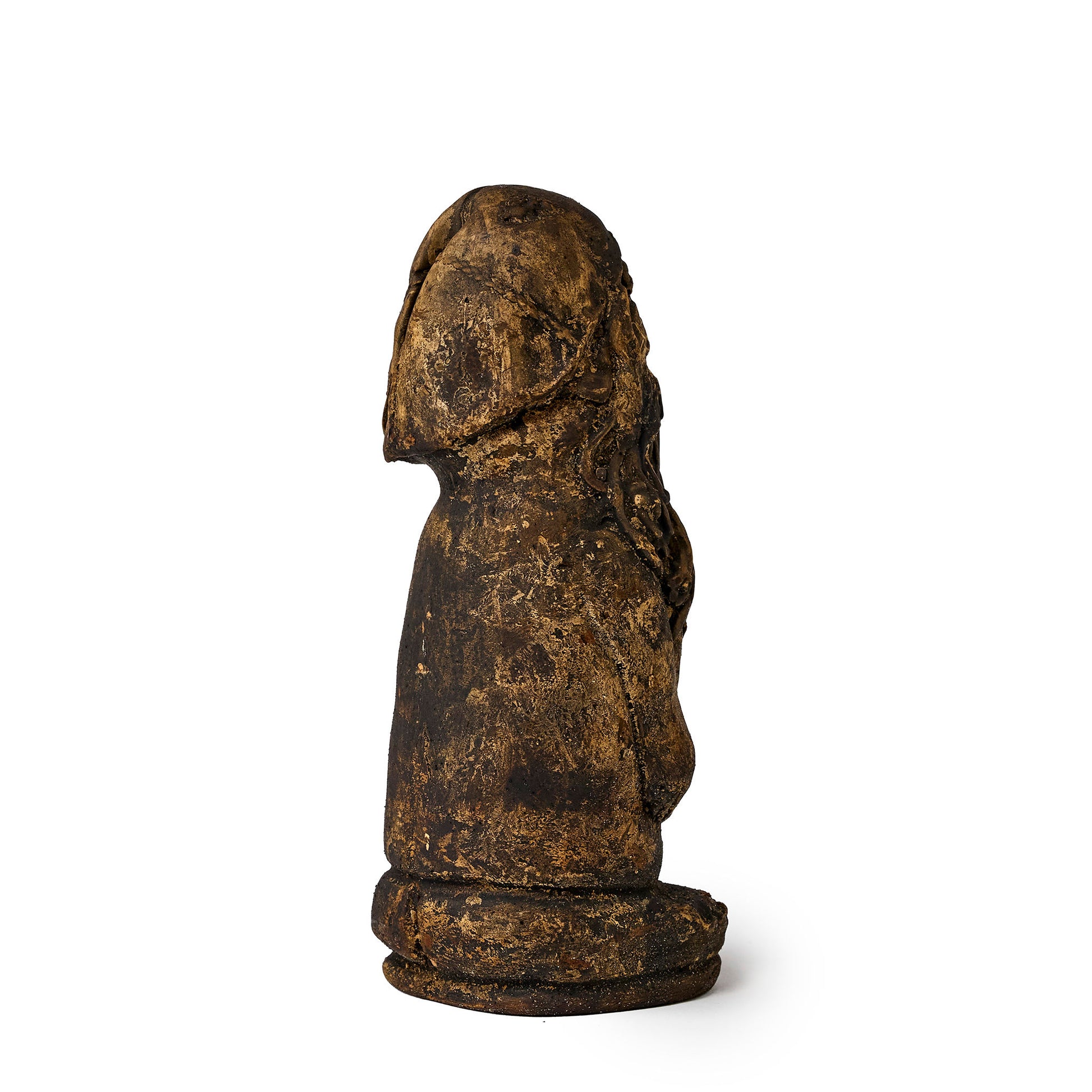 Small figure of an elf covered in pine tar rear view