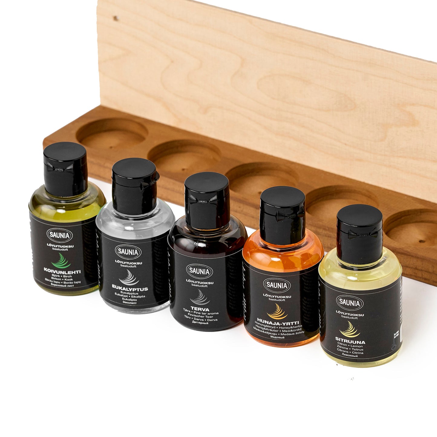 Wooden tray with five scent bottles aligned in a row, view of bottles close up.