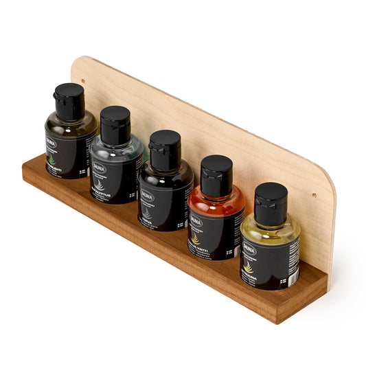 Wooden tray with five scent bottles aligned in a row, top view