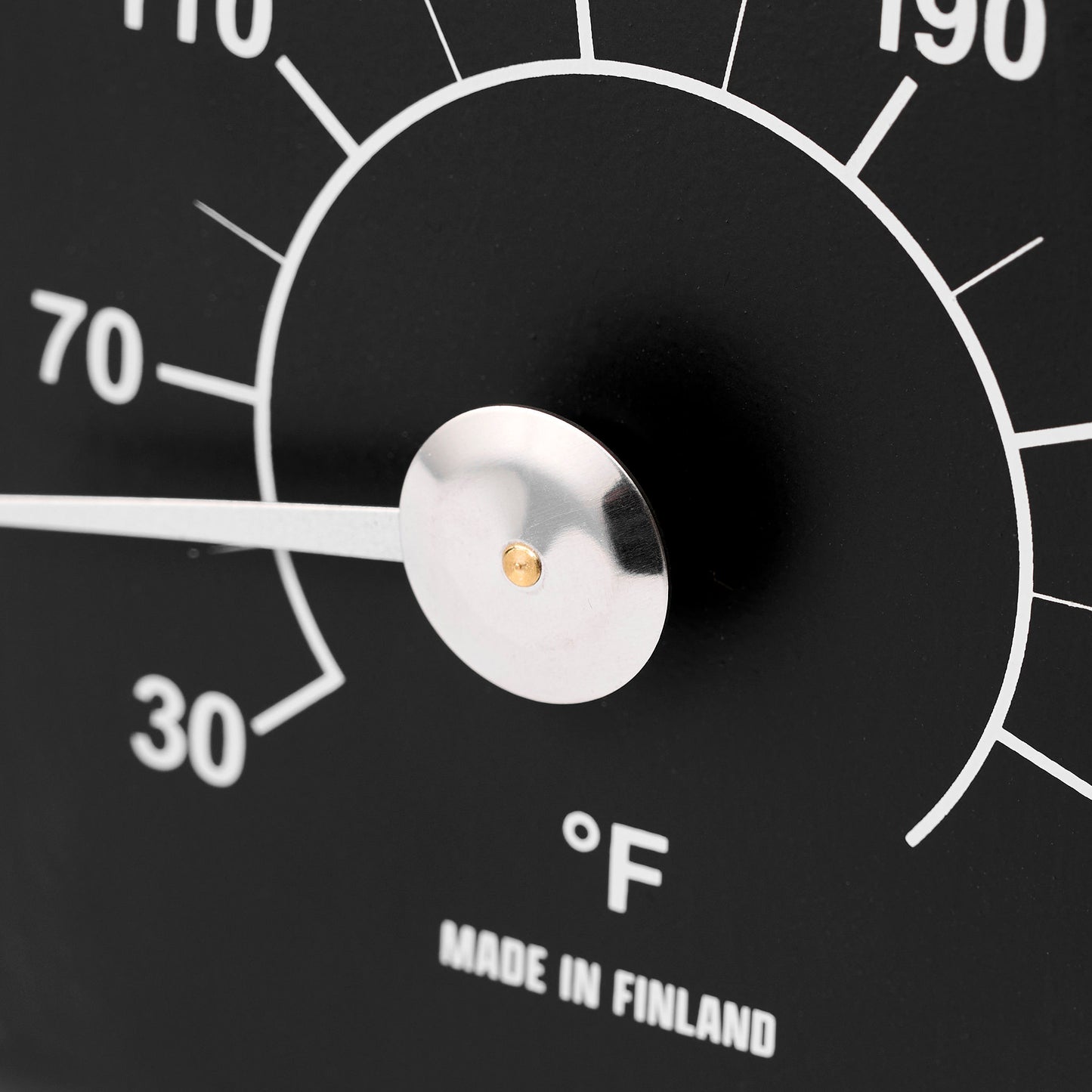 Black thermometer with temperature markings close up view