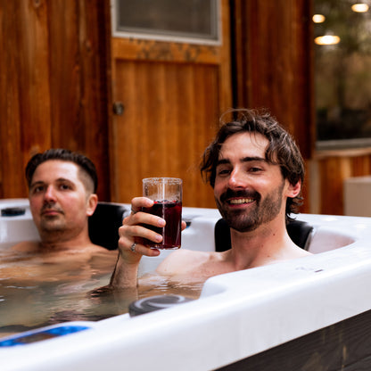 Two dudes sitting in a hot tub by Redwood Outdoors. The Sequoia 3 person hot tub.