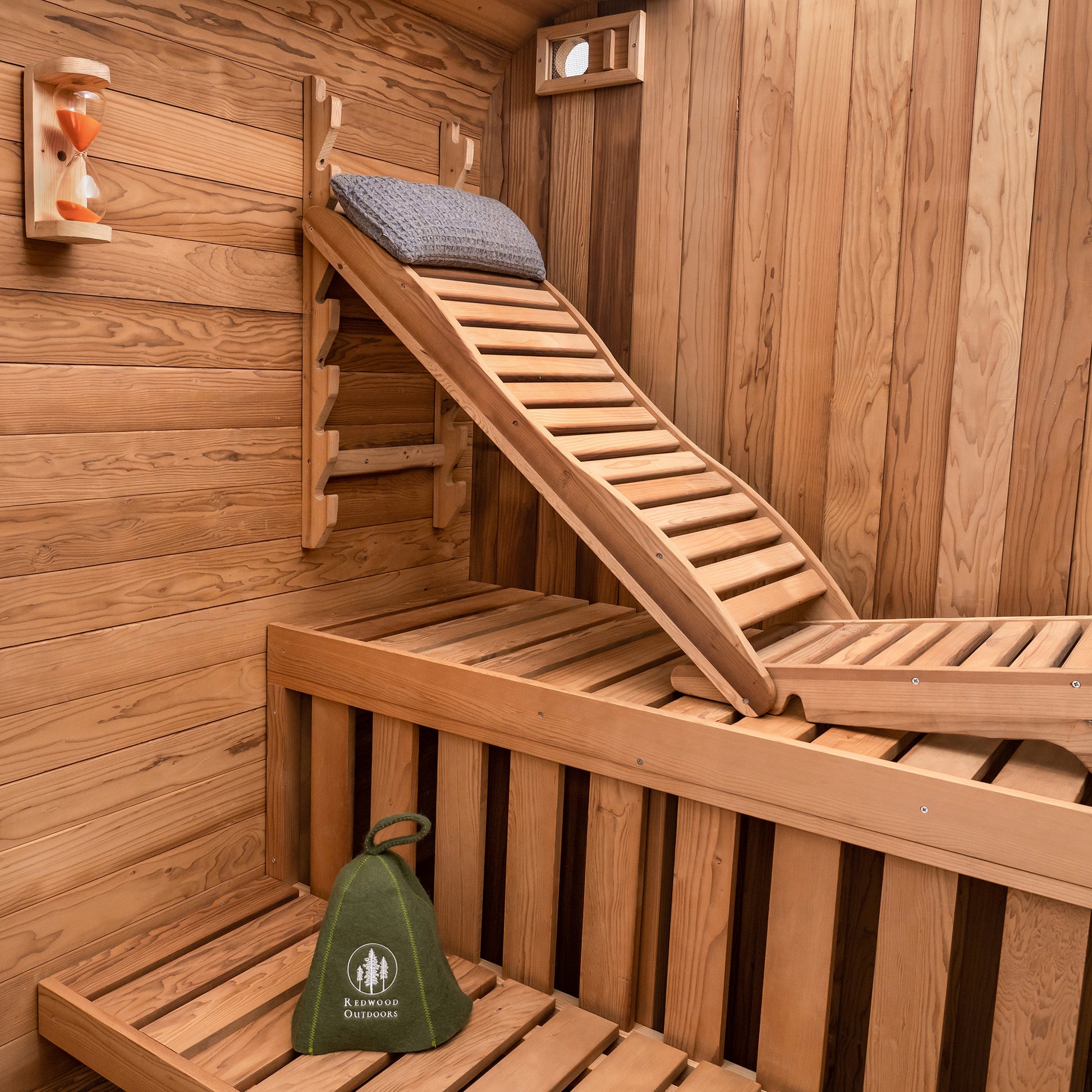 Redwood Outdoors Summit 6 person outdoor sauna, made of hemlock wood interior view of sauna with accessories.
