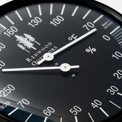 Black thermometer and hygrometer combo, 5 inch dial with white lettering close up view