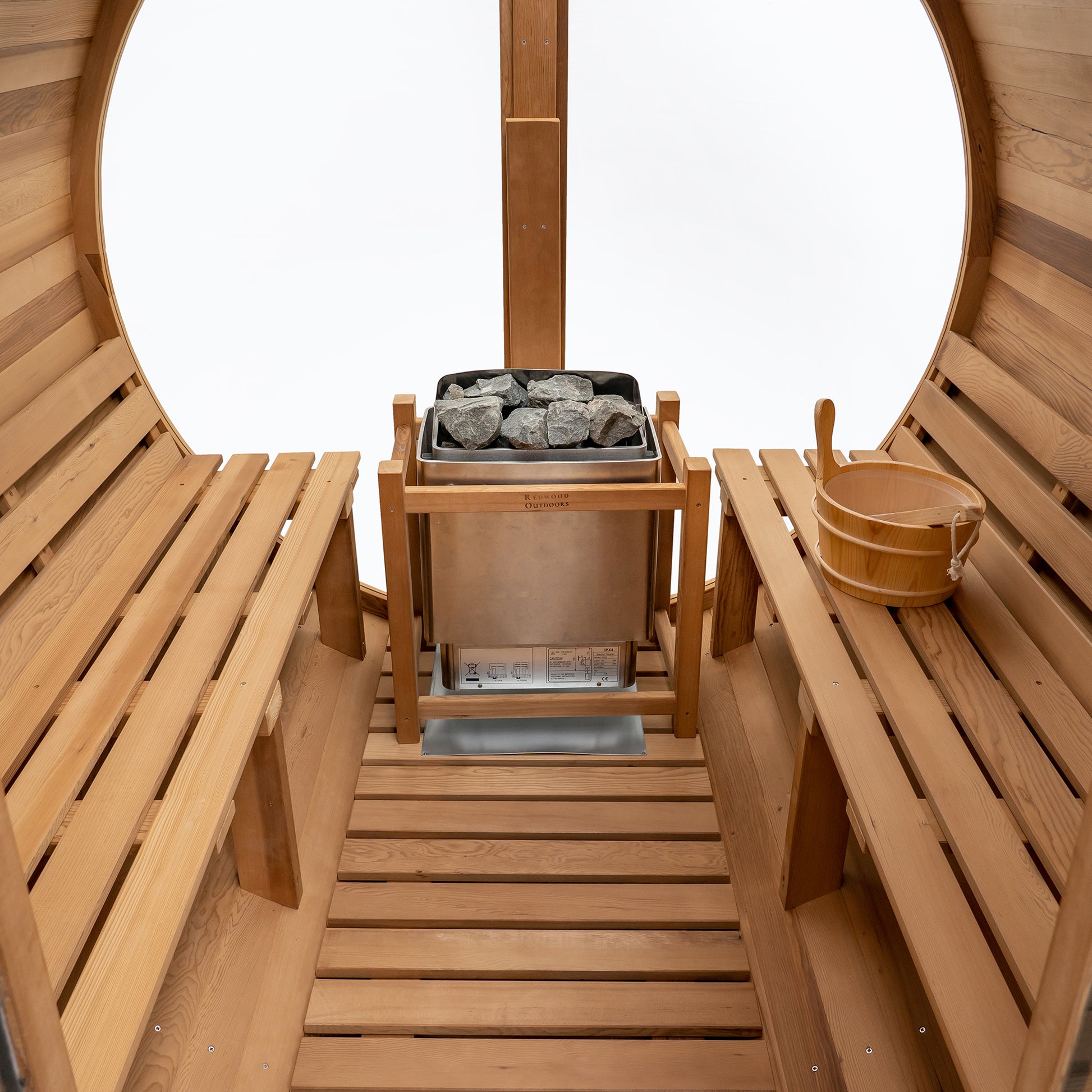 Redwood Outdoors Vista 6 person outdoor sauna, made of hemlock wood with large rear window, heater with guard and two benches on both sides. 